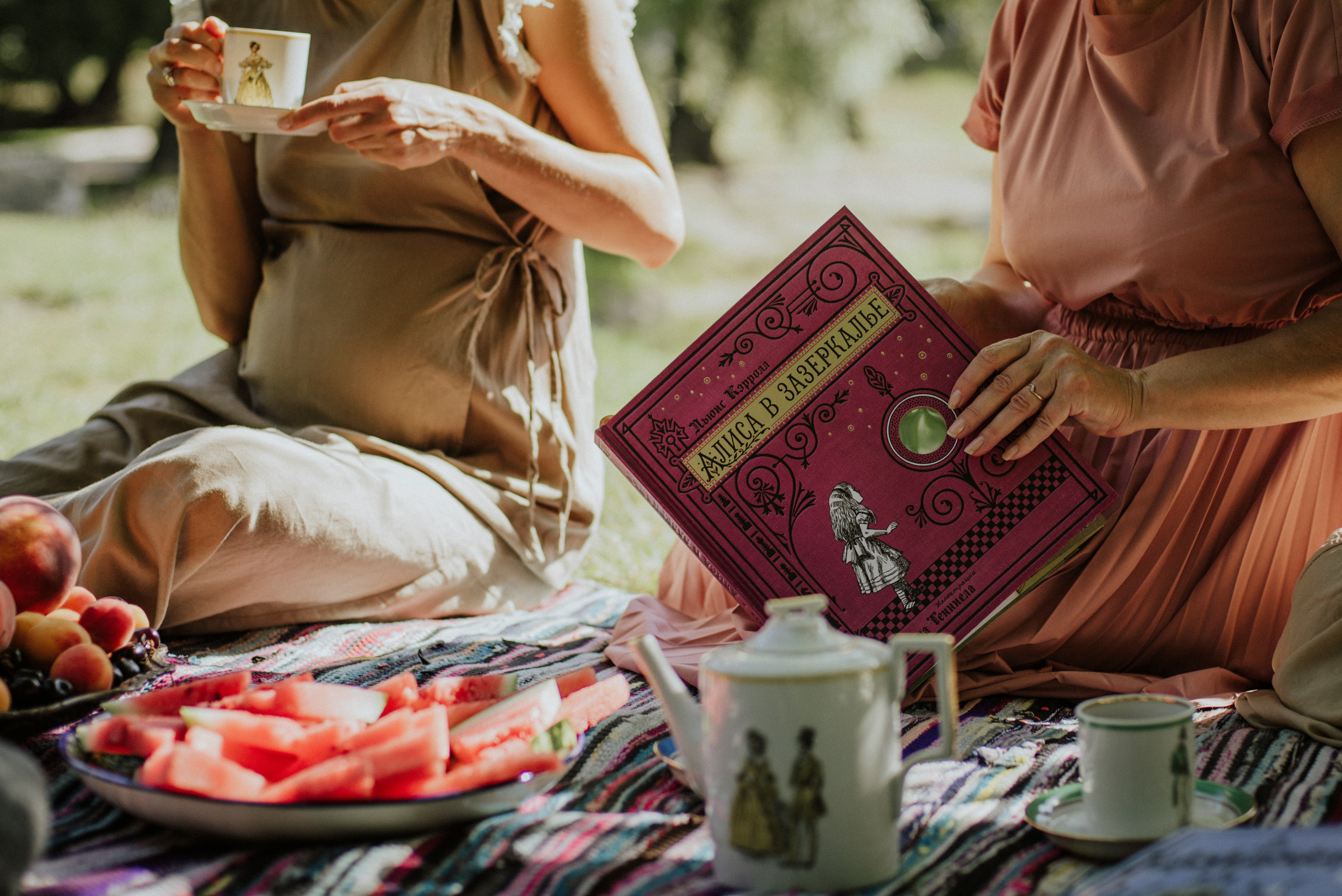 woman in pink dress holding book